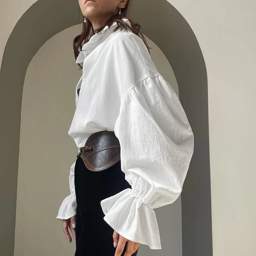 Lola Blouse à col V. Manches bouffantes. Manches longues.